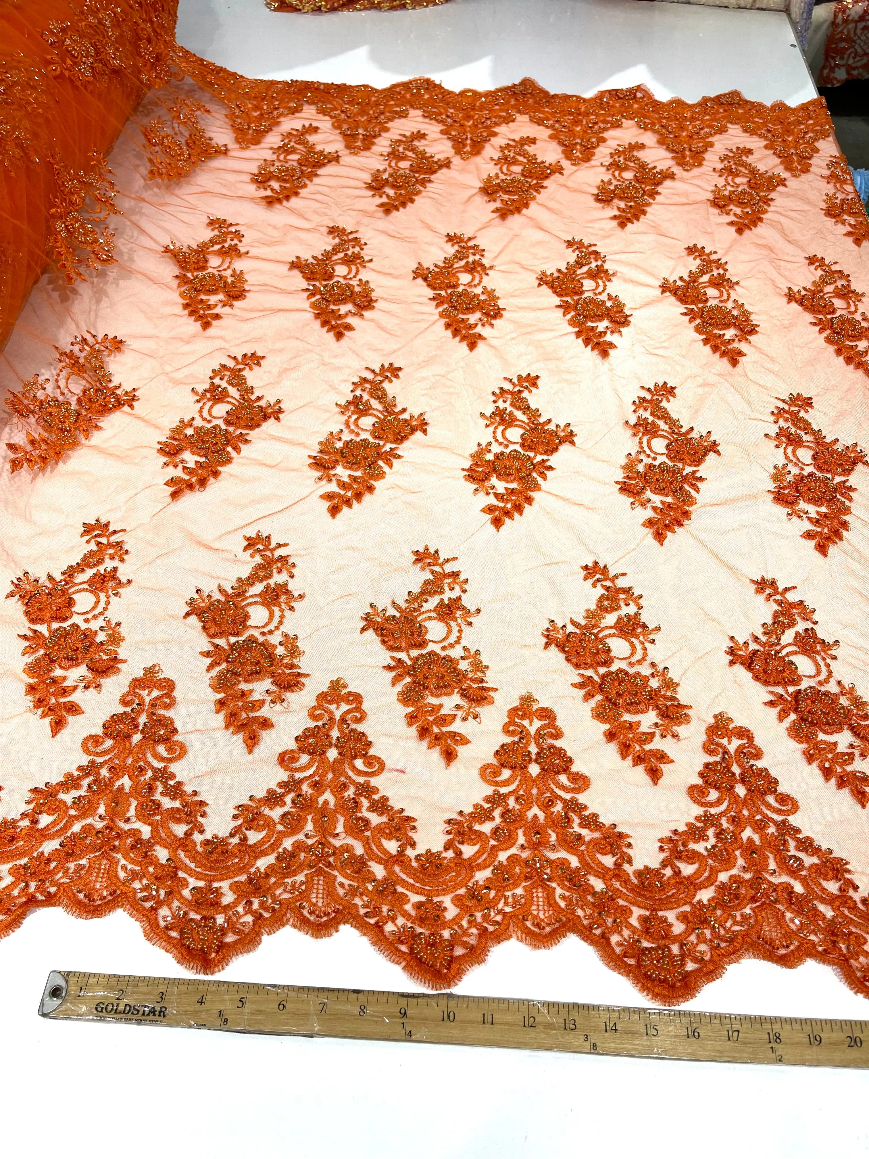 Orange elegant hand beaded flower design embroider on a mesh lace-prom-sold by the yard.